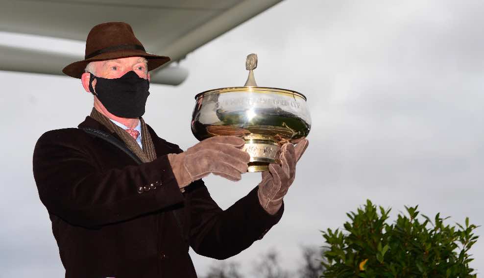 Willie Mullins shows off the prize for one of the nine races his horses won at Leopardstown