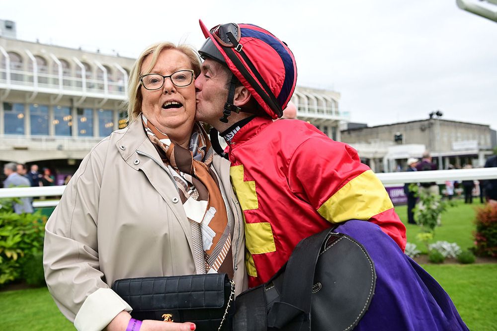 Musical Rhapsody winning jockey gives owner Helen Keaveney a kiss after their win 